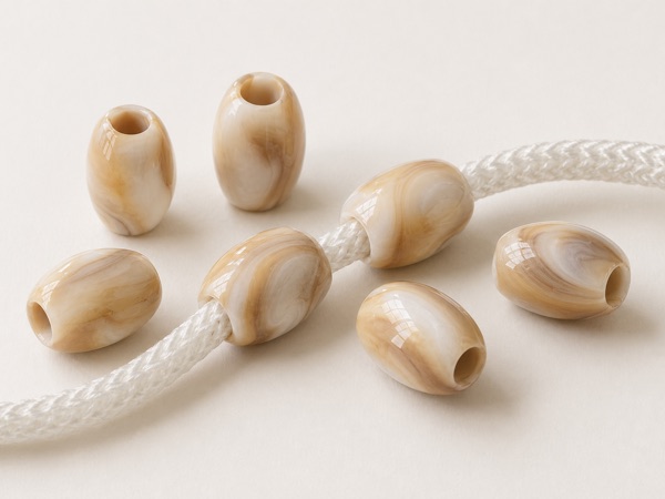 Assorted garment trim beads including seed beads, pearls, and faceted beads.