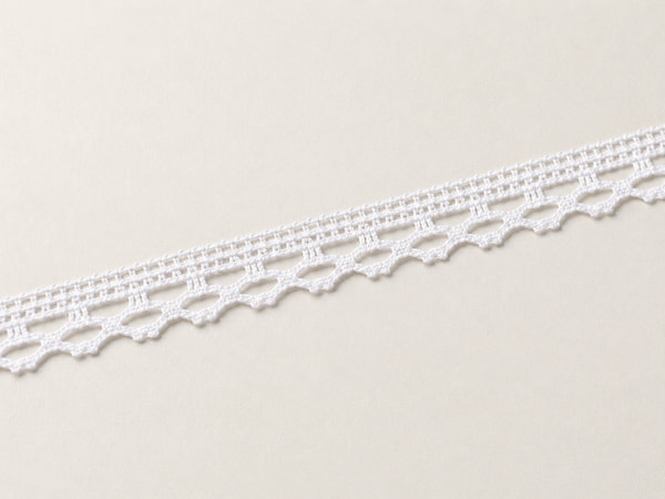 Cotton lace trims with crocheted texture and scalloped edges.