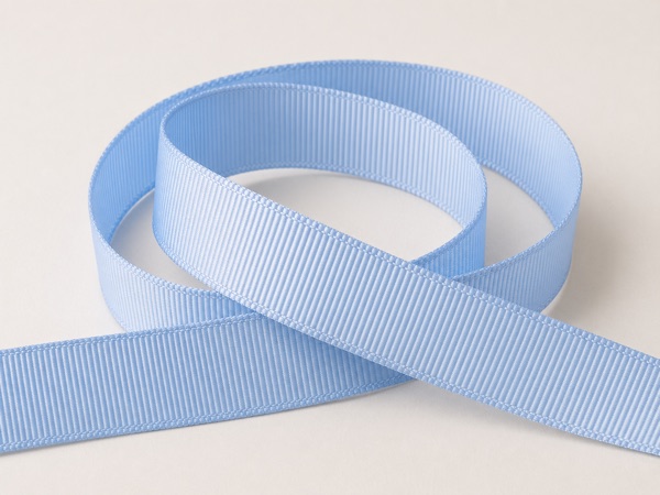 Grosgrain ribbons with visible ribbed texture in soft neutral colors.