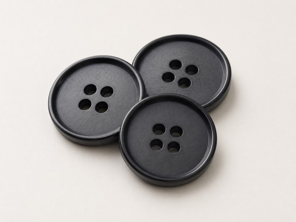 Assorted polyester apparel buttons in pearl, translucent, and matte finishes.