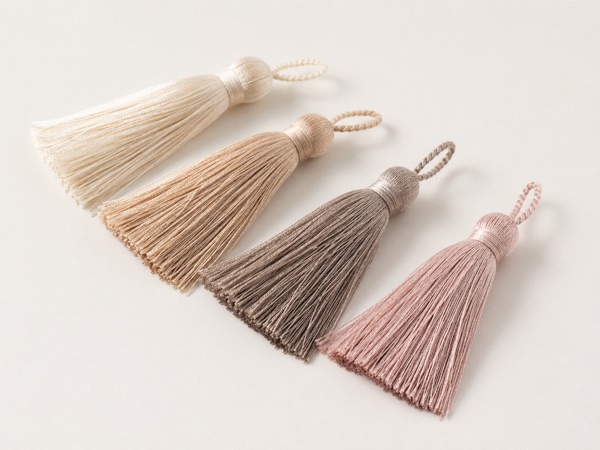 Silky garment tassels in ivory, champagne, taupe, and muted blush.